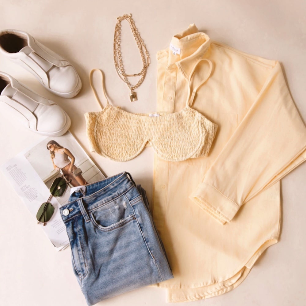 Jeans, sunglasses, shoes, shirt, and a bra flatlay - PRIMP